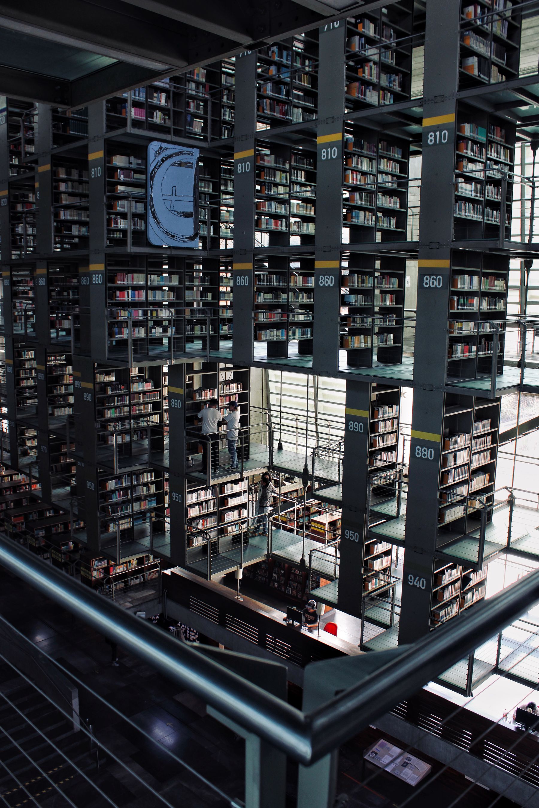 A dramatic contemporary library interior with shelves rising through an open atrium